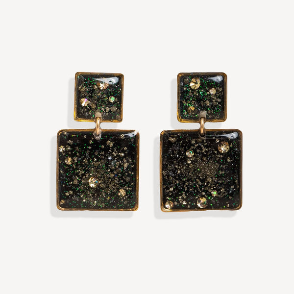 Pair of square-shaped earrings with green and gold glittery finish on a white background