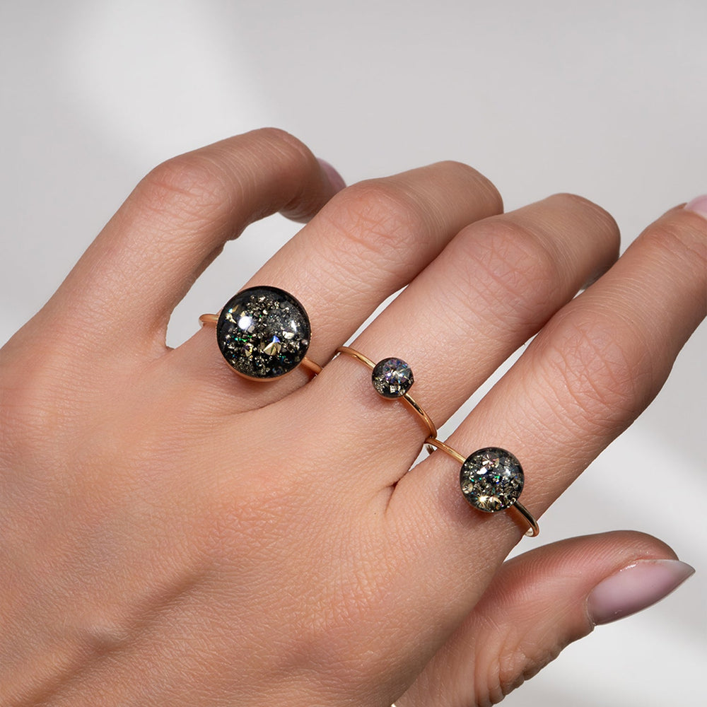 Gold ring with a black gemstone on a white background