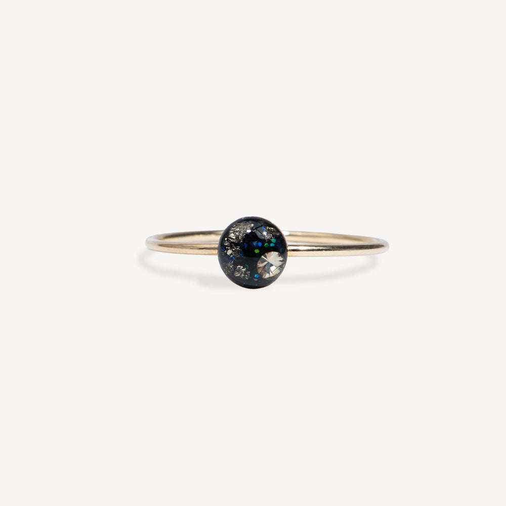 Gold ring with a black gemstone on a white background