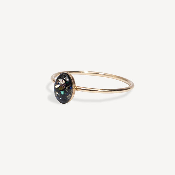 Gold ring with a black gemstone on a white background