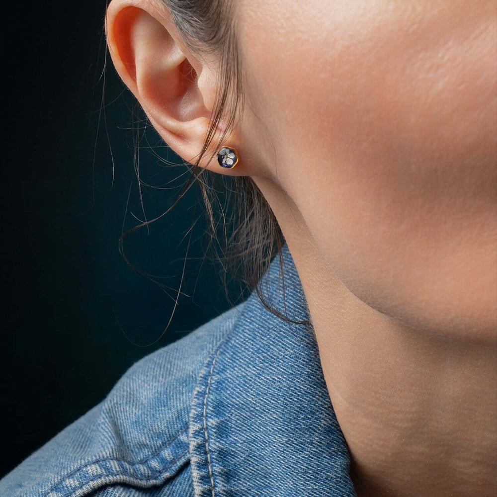 Violet hexagon stud earrings with real pressed flowers
in gold-plated brass by Kate Koel