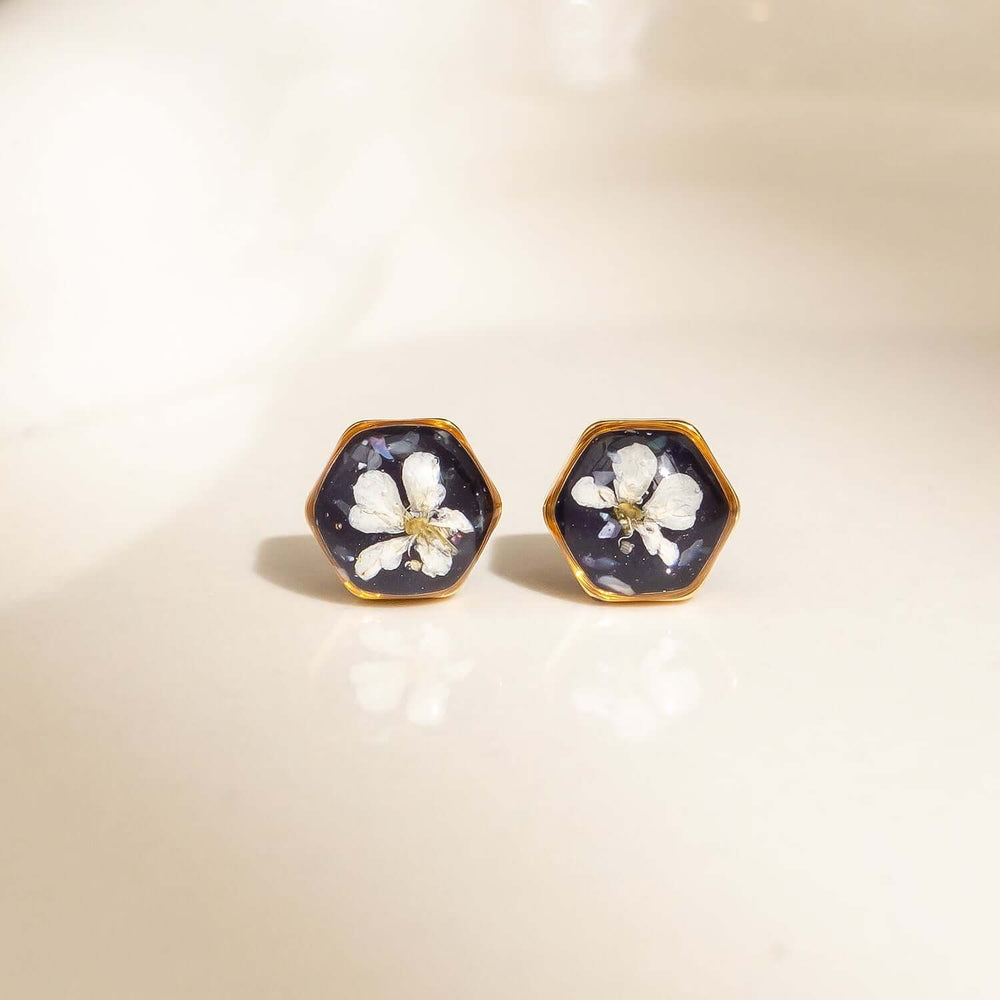 Violet hexagon stud earrings with real pressed flowers
in gold-plated brass by Kate Koel