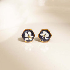 Violet hexagon stud earrings with real pressed flowers
in gold-plated brass by Kate Koel
