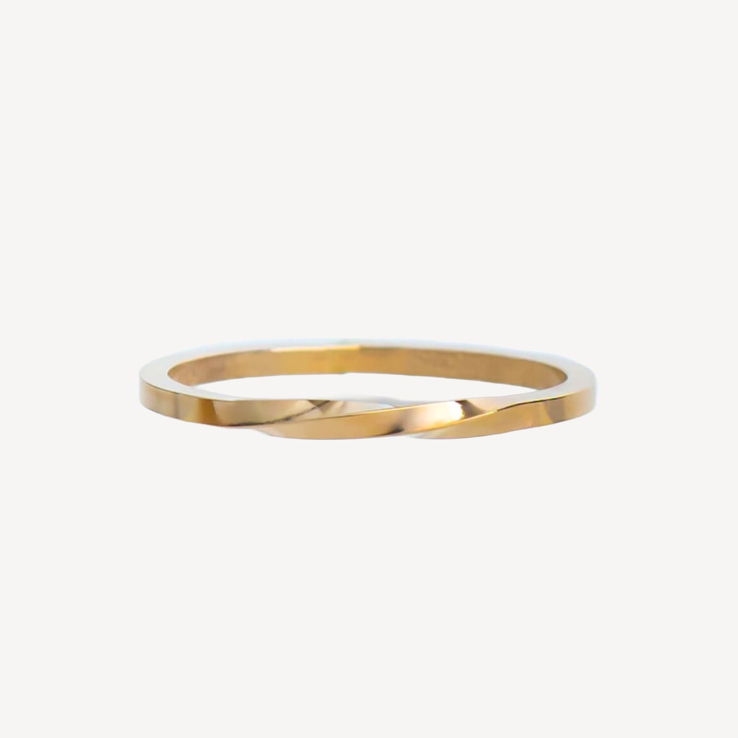 Gold stackable ring on a white background
