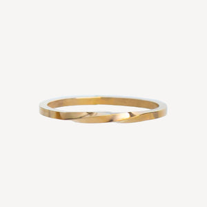 Gold stackable ring on a white background