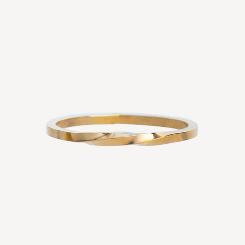 Gold stackable ring on a white background