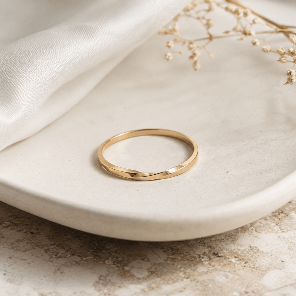Gold stackable ring on a white background